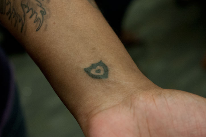 A woman with a tattoo of the Loving Day logo